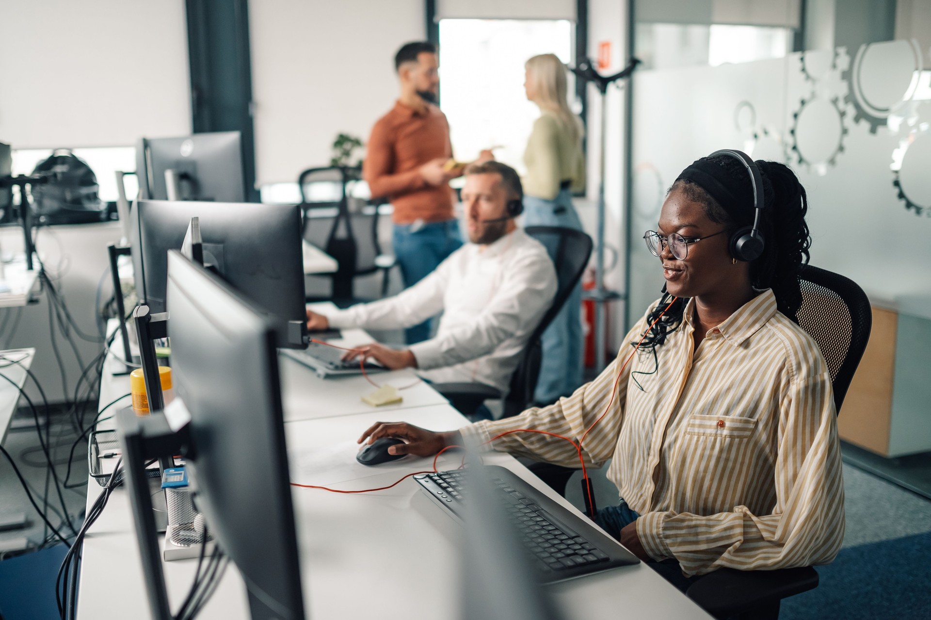 Customer service representative working in busy call center office